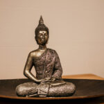 Gold buddha figurine on brown wooden table